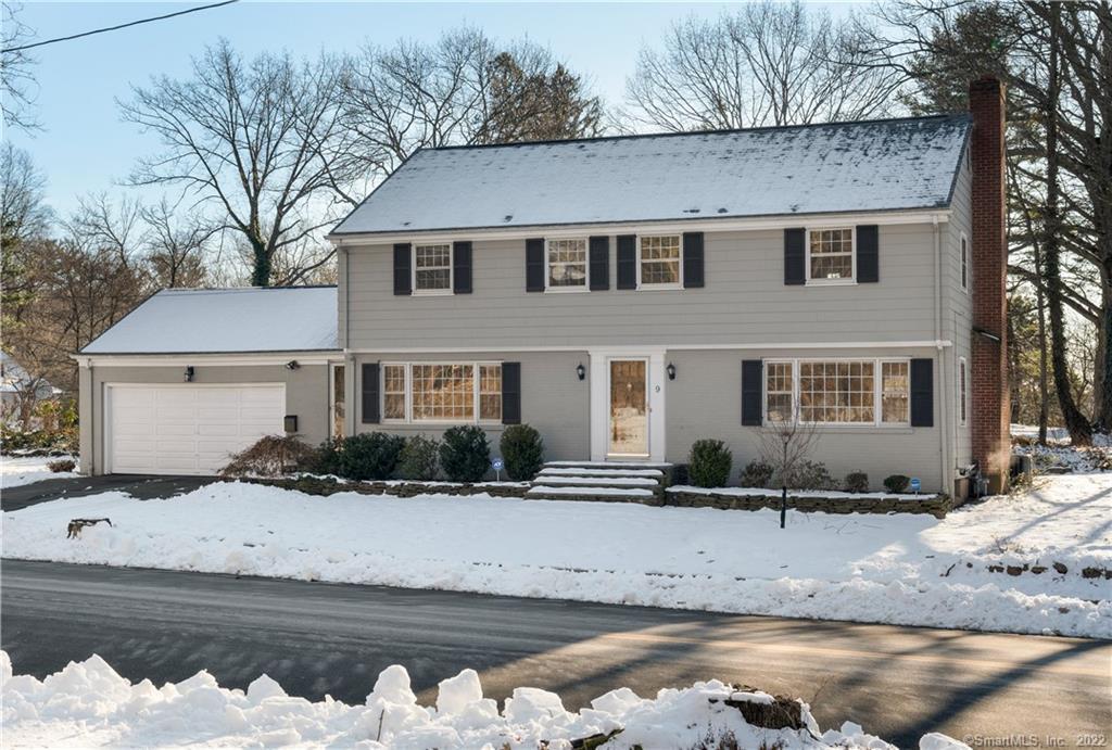 a view of a house with a yard covered in snow