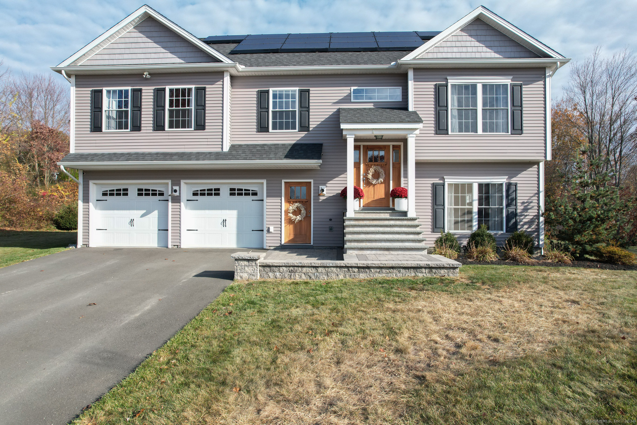 a front view of a house with a yard