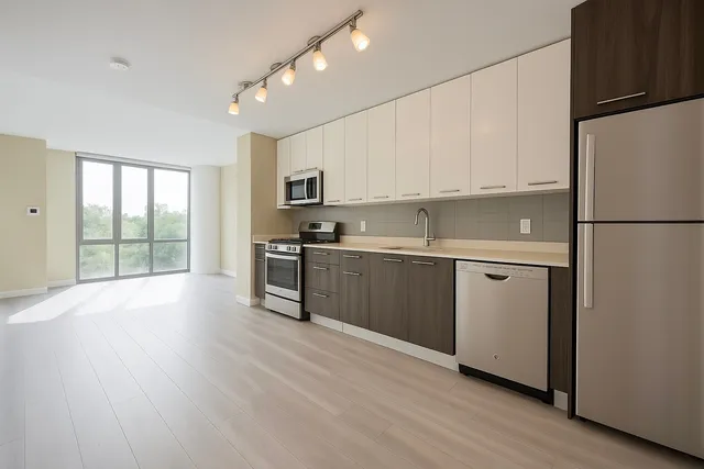 a kitchen with a refrigerator a stove top oven and a refrigerator