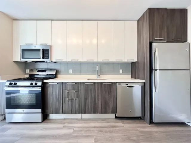 a kitchen with a refrigerator stove and microwave