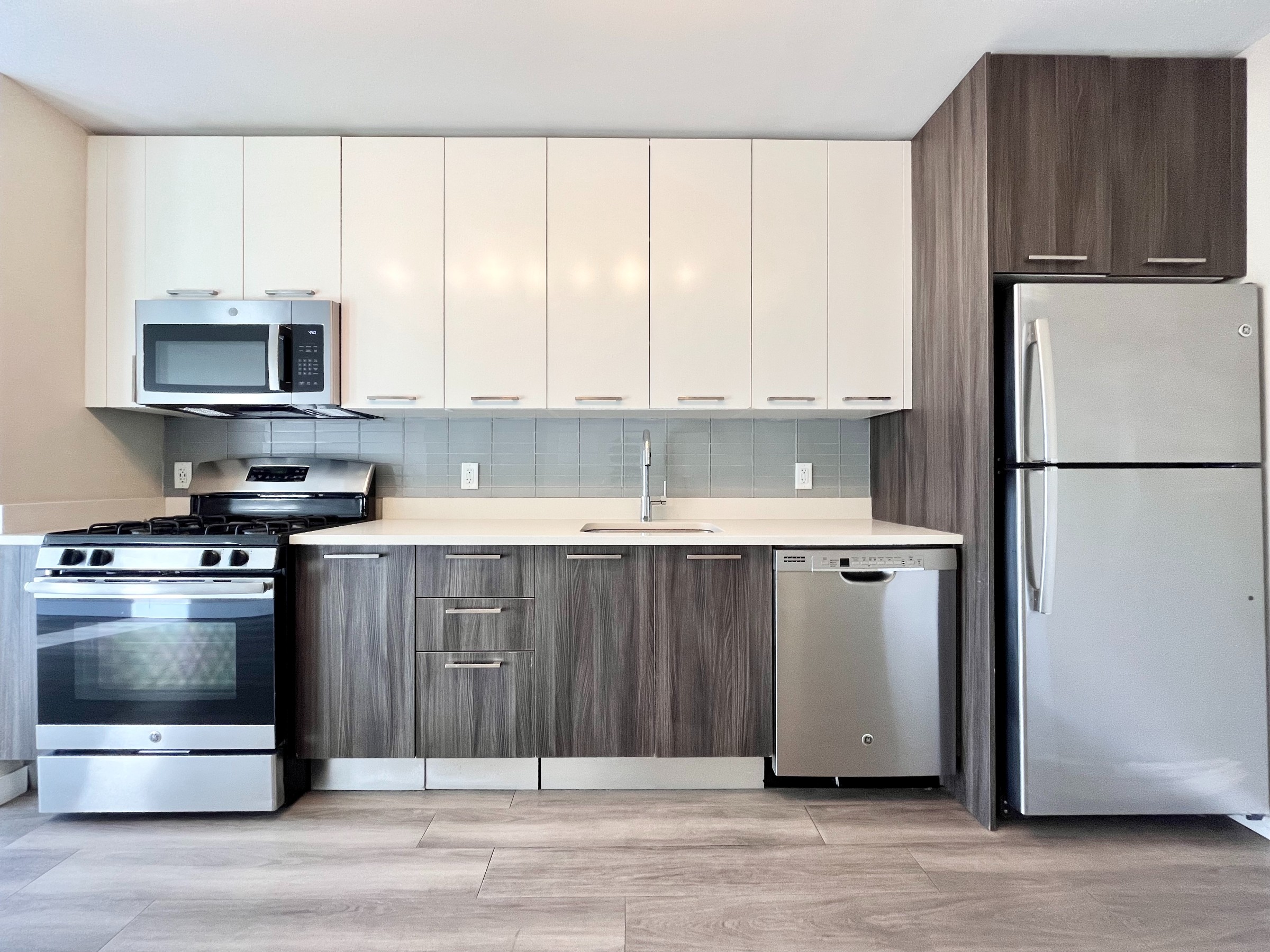 1524 Sheepshead Bay Road, Unit 6D Brooklyn, NY 11235 - Photo 6 of 25 a kitchen with a refrigerator stove and microwave