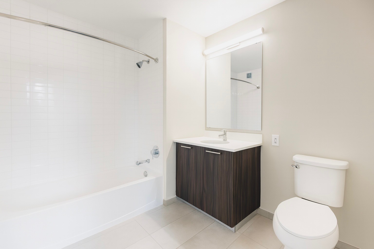 1524 Sheepshead Bay Road, Unit 6D Brooklyn, NY 11235 - Photo 7 of 25 a bathroom with a sink a toilet and shower