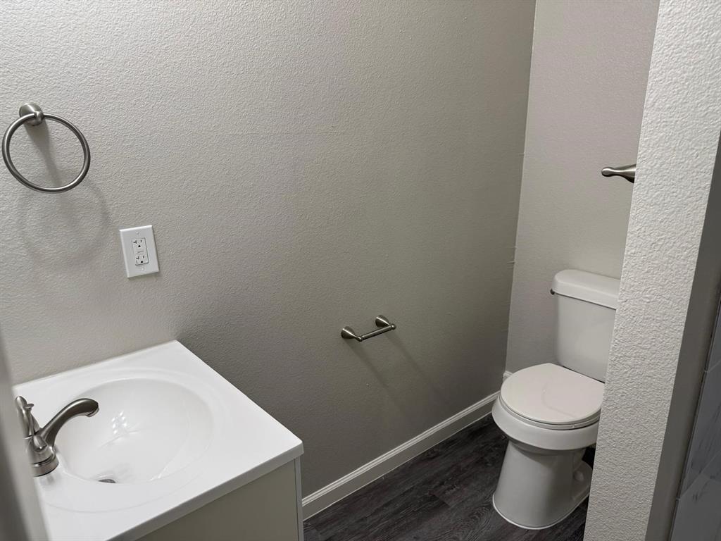 925 Bluewood Drive Dallas, TX 75232 - Photo 15 of 33 a bathroom with a toilet and a sink