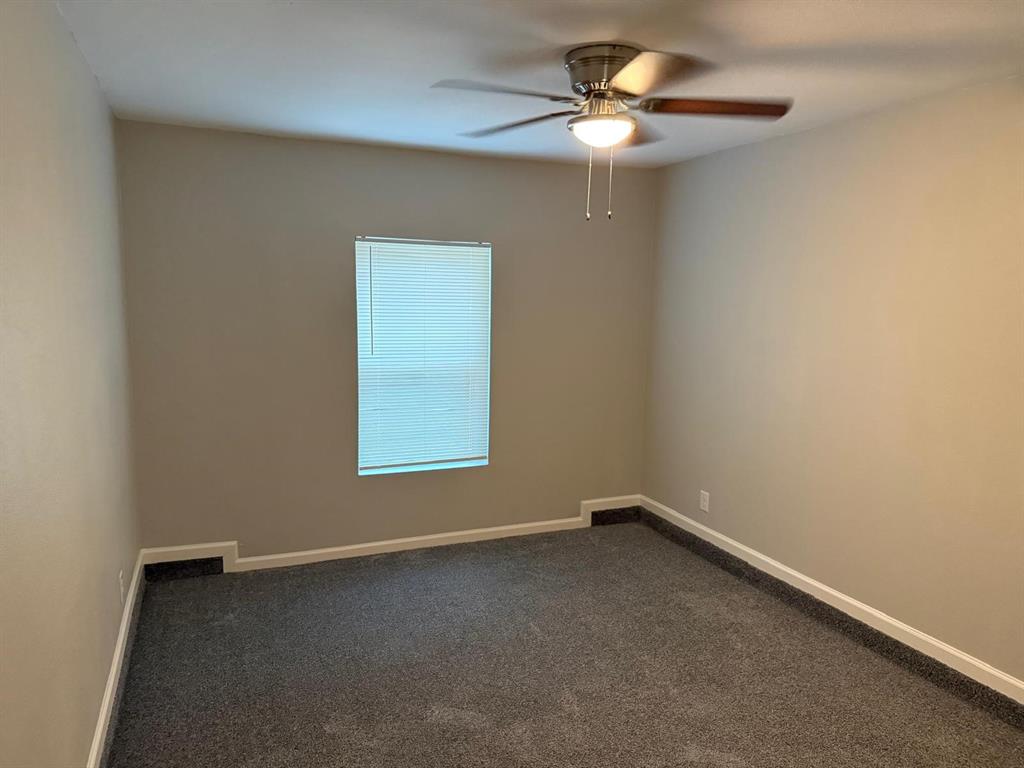 925 Bluewood Drive Dallas, TX 75232 - Photo 16 of 33 an empty room with a window and a fan