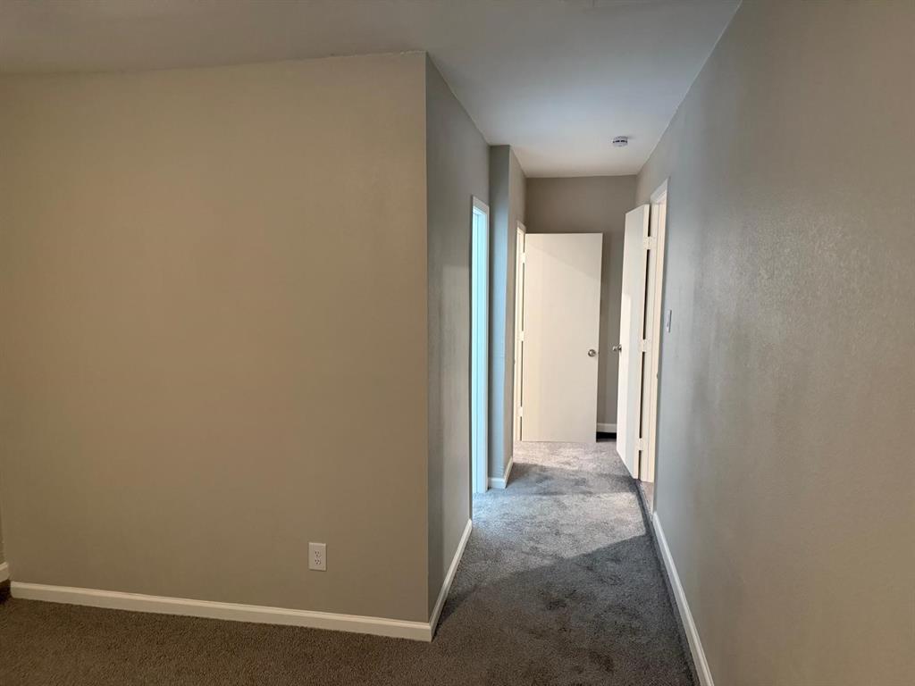 925 Bluewood Drive Dallas, TX 75232 - Photo 21 of 33 a view of a room with wooden floor