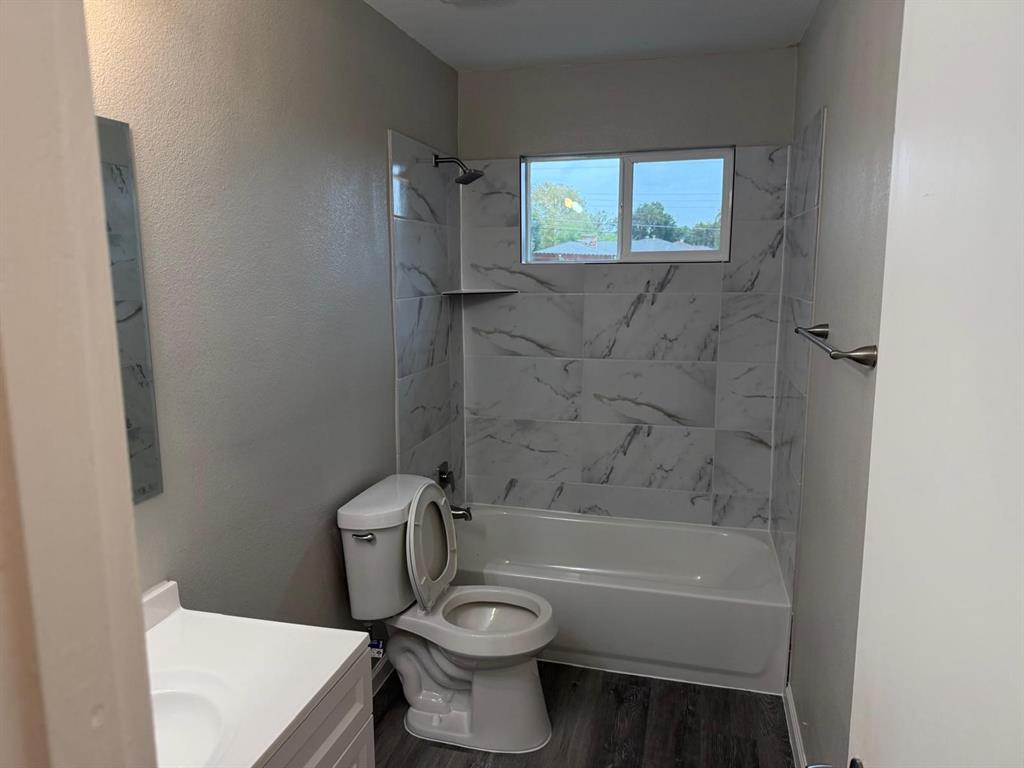 925 Bluewood Drive Dallas, TX 75232 - Photo 6 of 33 a white toilet sitting next to a bath tub