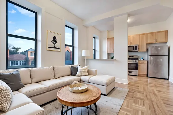 a living room with furniture and kitchen view