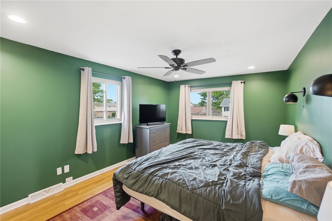 150 Littlejohn Road Troy, OH 45373 - Photo 21 of 40 This inviting bedroom features hardwood floors and ample natural light, perfect for relaxation.
