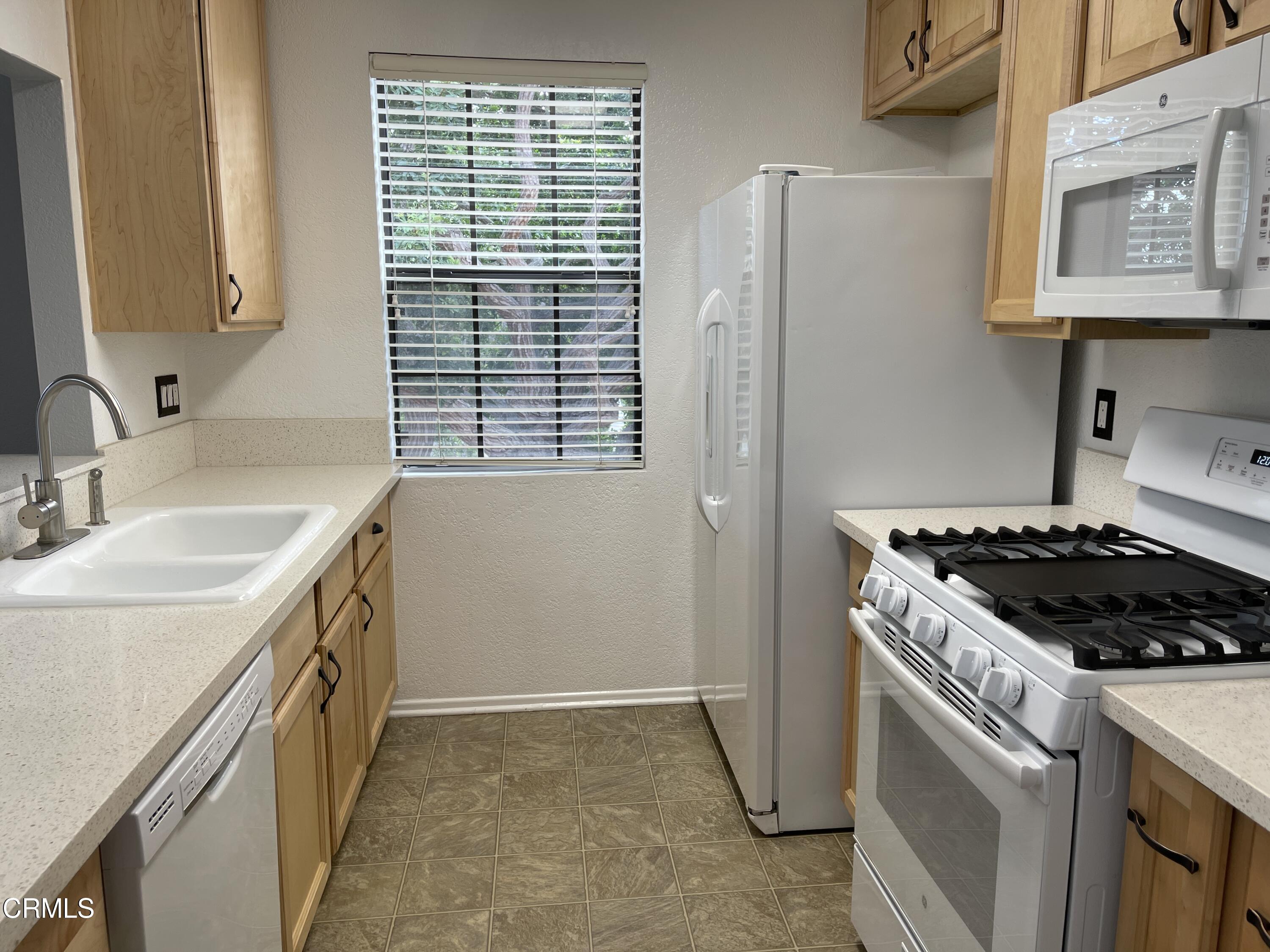 2257 Martinique Lane Oxnard, CA 93035 - Photo 11 of 52 a kitchen with a stove and a sink