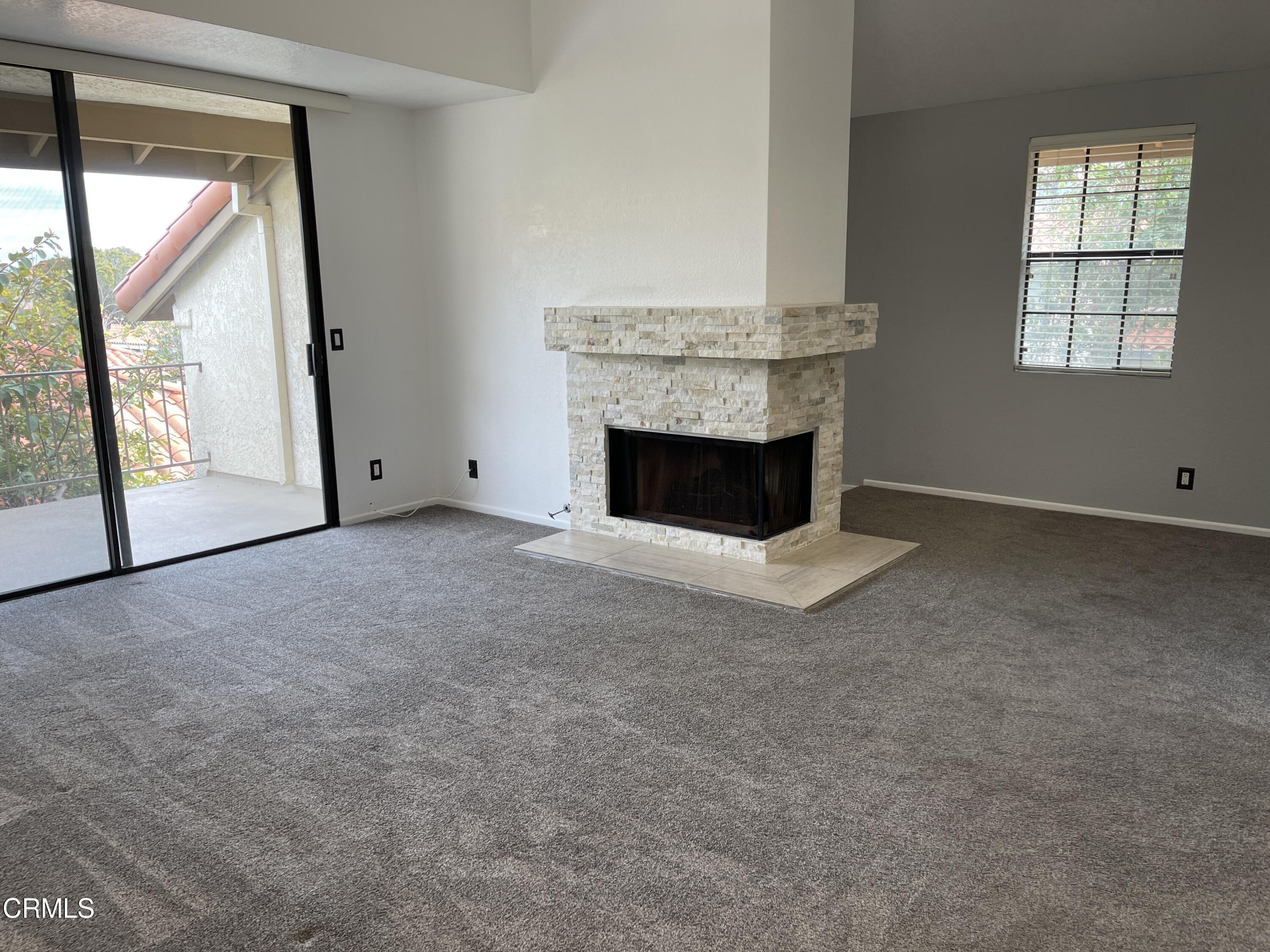 2257 Martinique Lane Oxnard, CA 93035 - Photo 15 of 52 an empty room with windows and fireplace