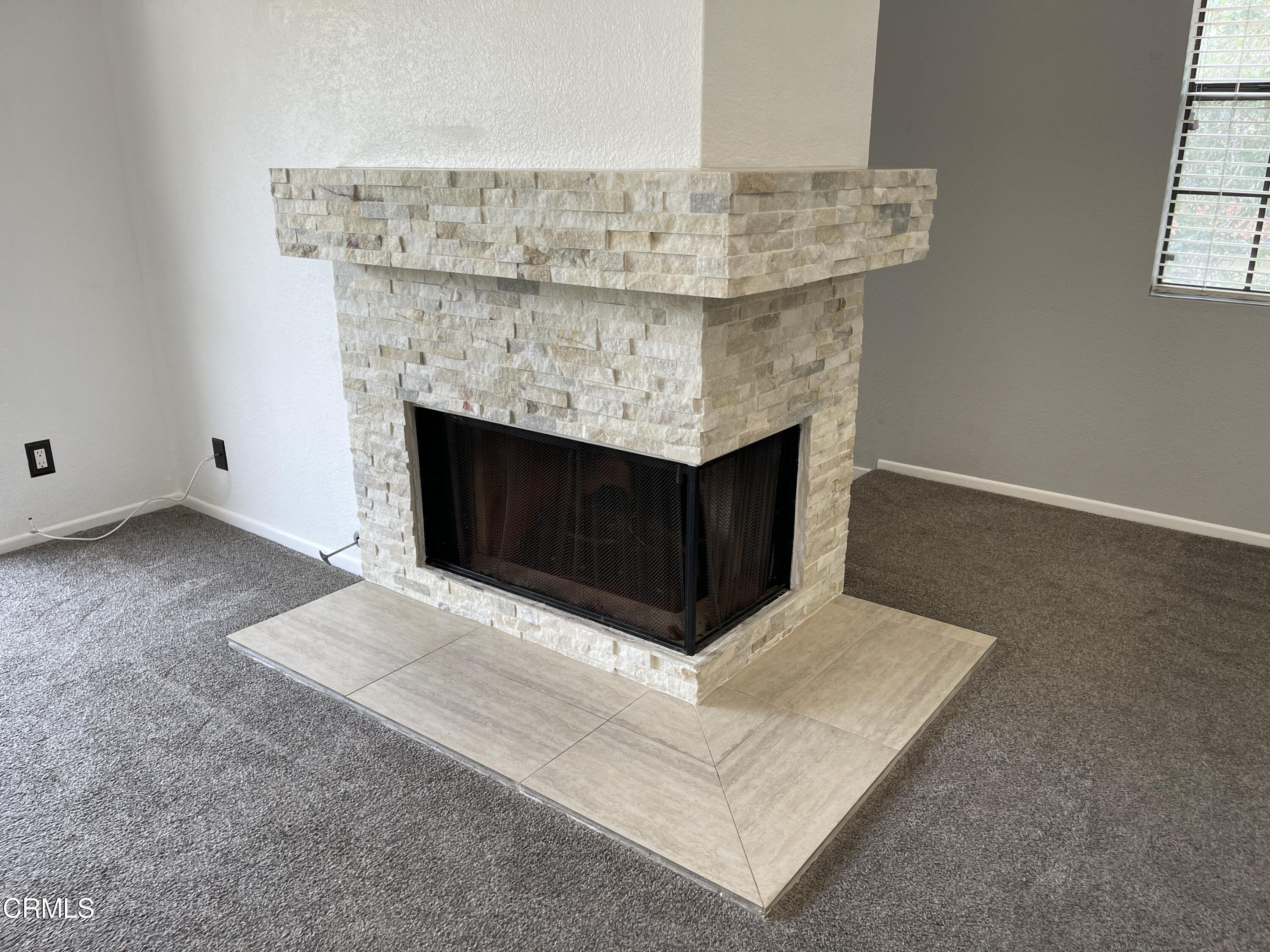 2257 Martinique Lane Oxnard, CA 93035 - Photo 16 of 52 a living room with furniture and a fireplace
