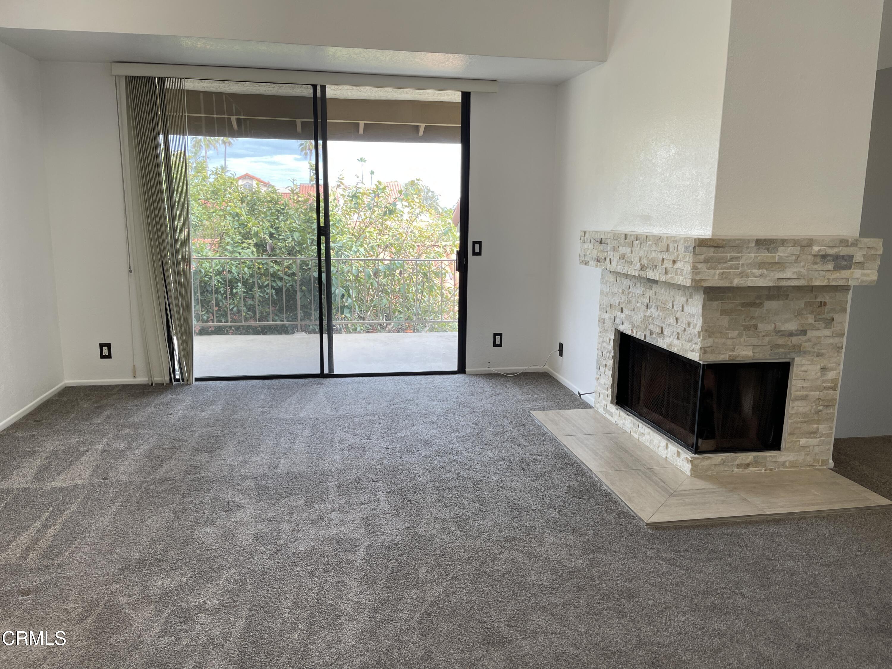 2257 Martinique Lane Oxnard, CA 93035 - Photo 17 of 52 a view of an empty room with a fireplace and a window