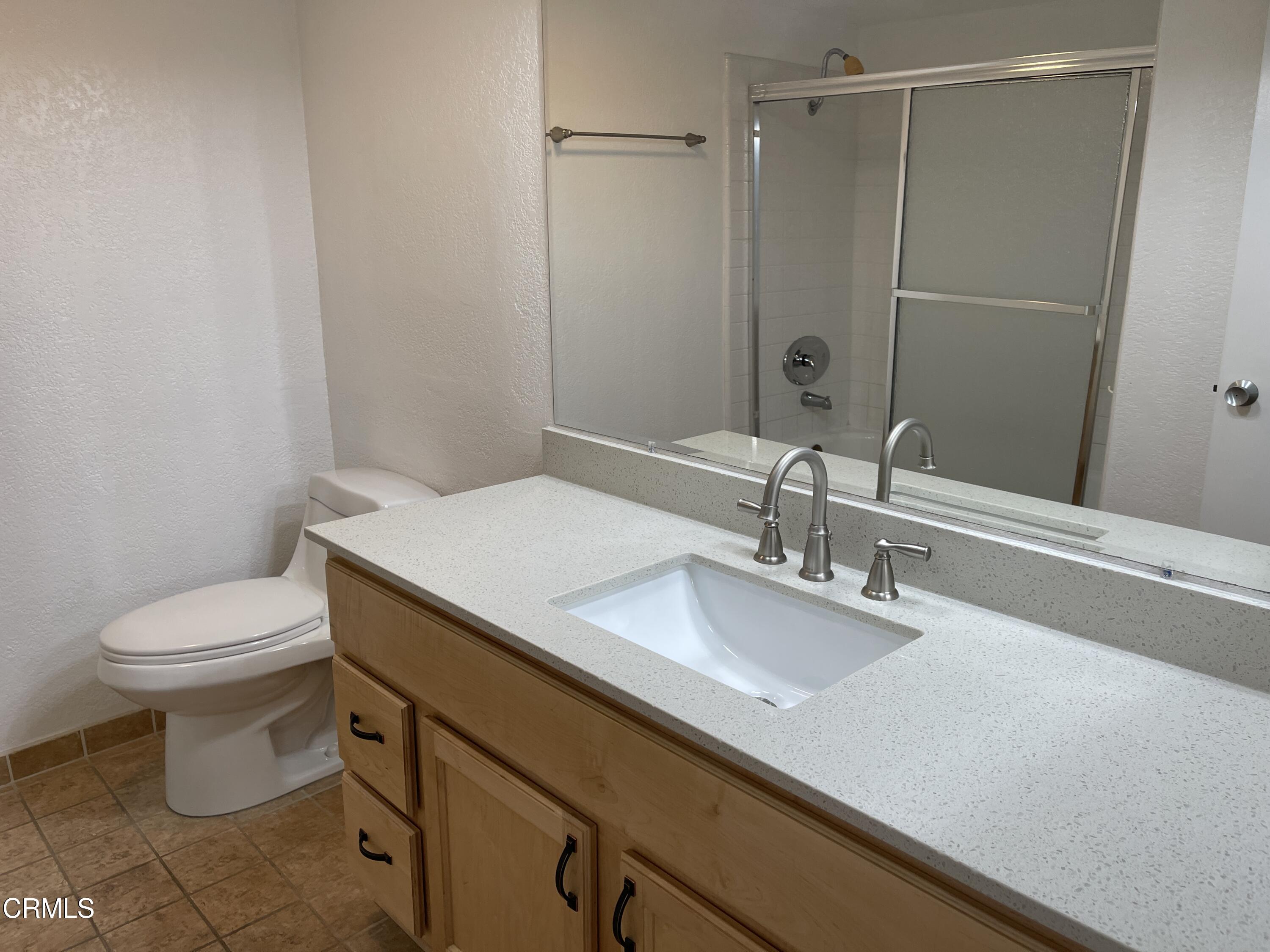 2257 Martinique Lane Oxnard, CA 93035 - Photo 23 of 52 a bathroom with a sink a toilet and shower