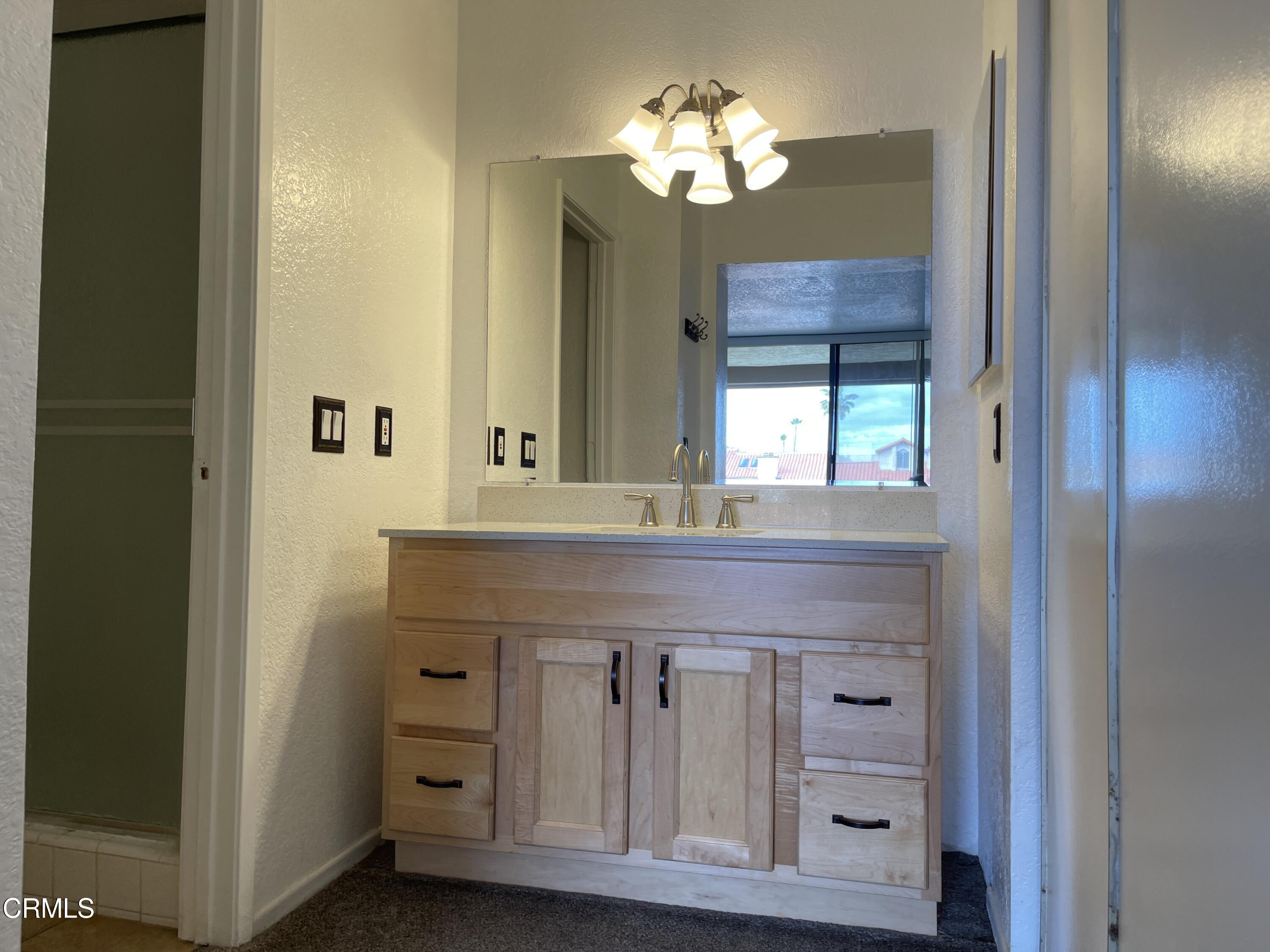 2257 Martinique Lane Oxnard, CA 93035 - Photo 26 of 52 a bathroom with a granite countertop sink and a mirror