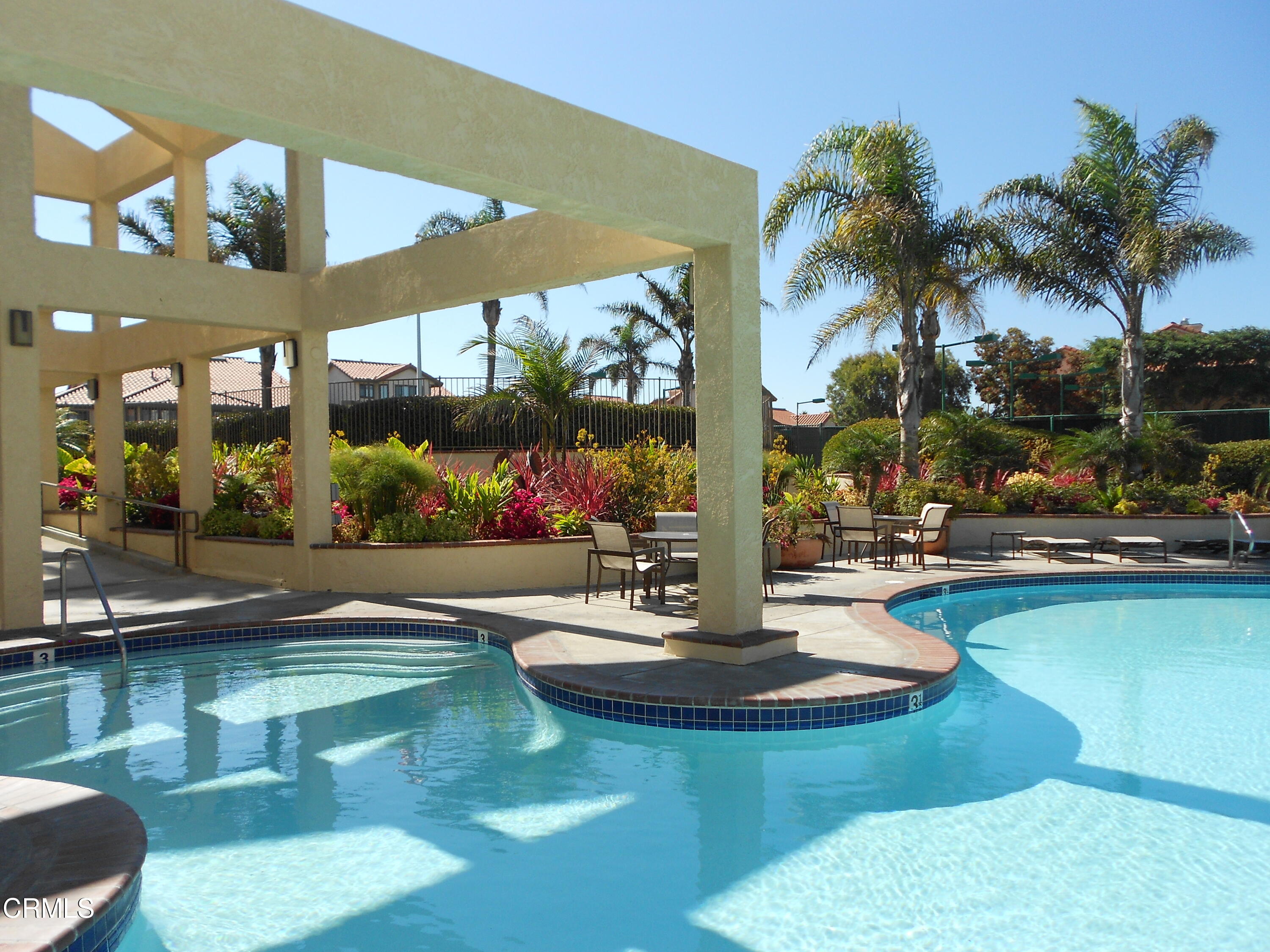 2257 Martinique Lane Oxnard, CA 93035 - Photo 39 of 52 a view of a swimming pool with a table and chairs