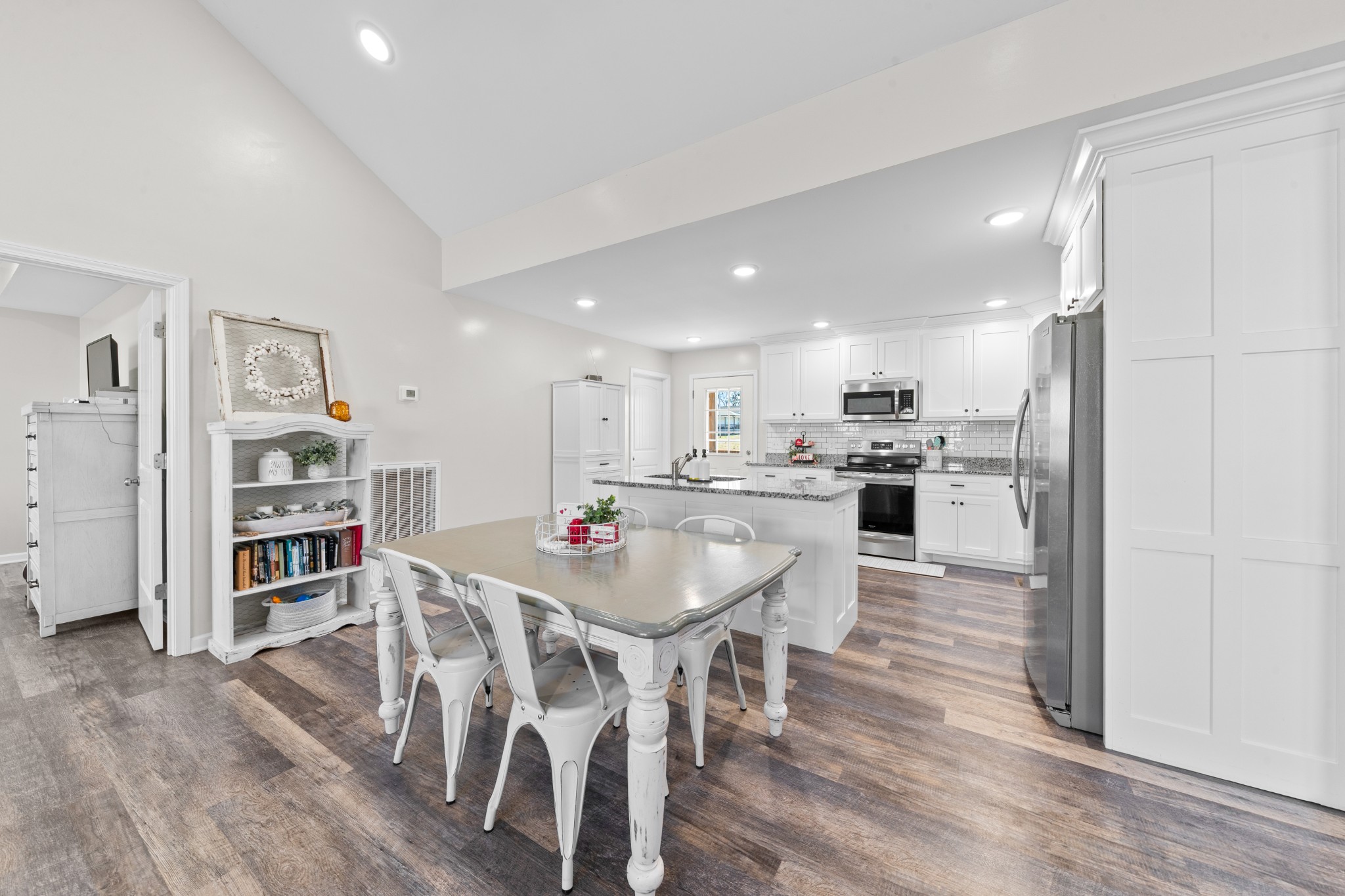 2023 Coleman Road Cornersville, TN 37047 - Photo 11 of 80 a kitchen with stainless steel appliances kitchen island granite countertop a table chairs and a refrigerator