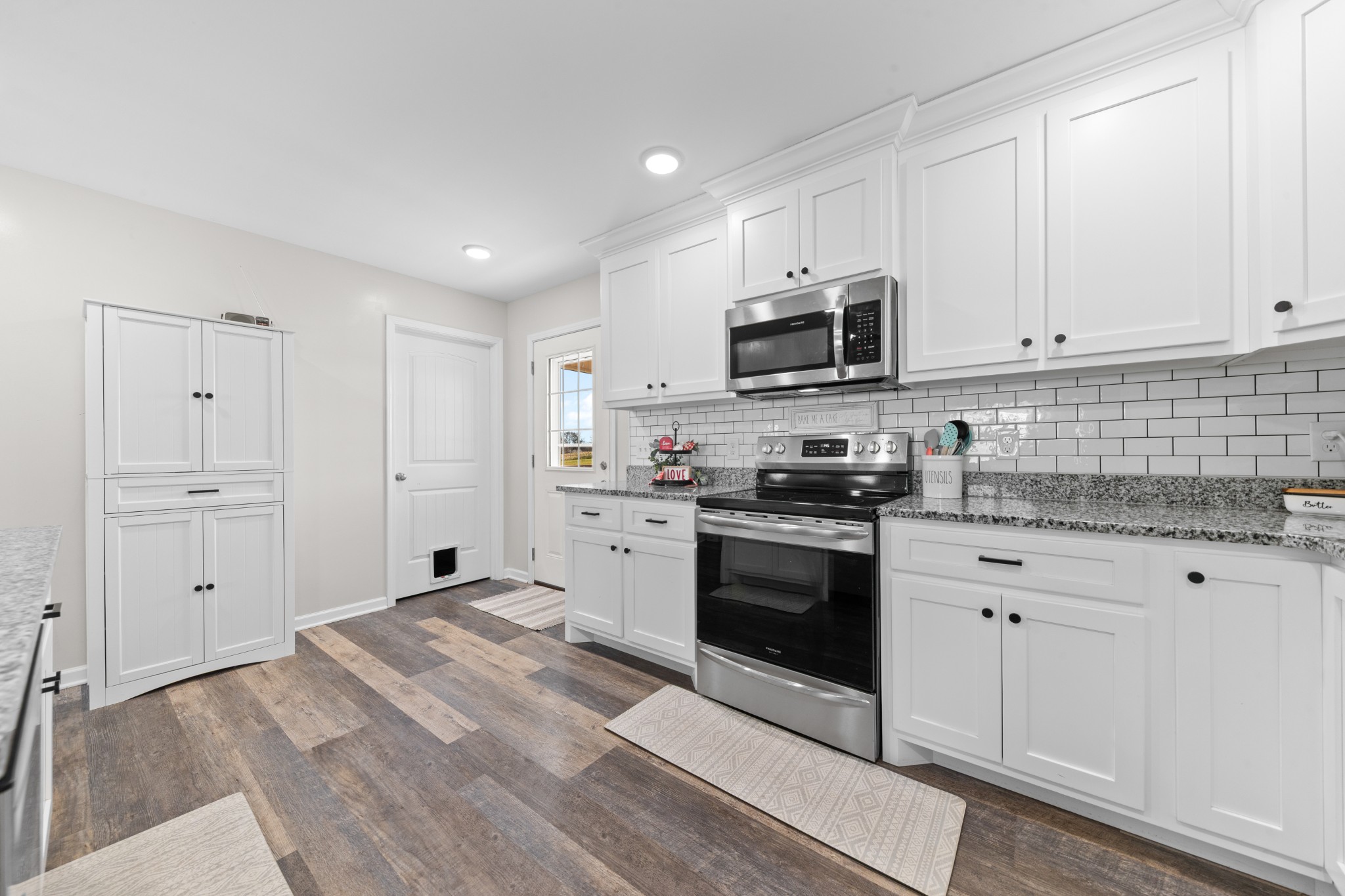 2023 Coleman Road Cornersville, TN 37047 - Photo 20 of 80 a kitchen with granite countertop white cabinets and stainless steel appliances