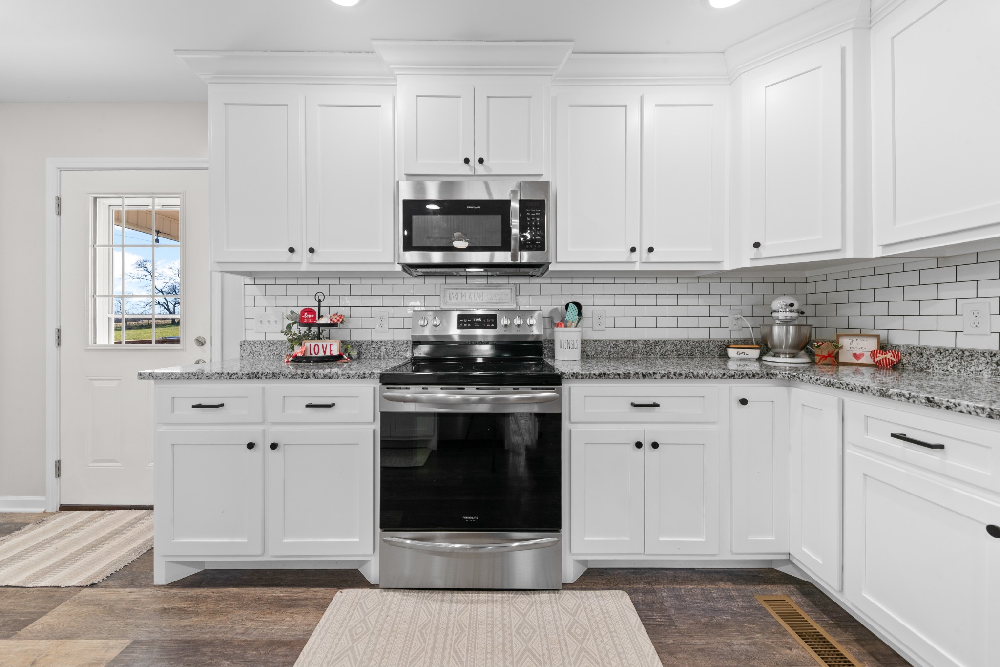 2023 Coleman Road Cornersville, TN 37047 - Photo 21 of 80 a kitchen with stainless steel appliances granite countertop a sink a stove and white cabinets