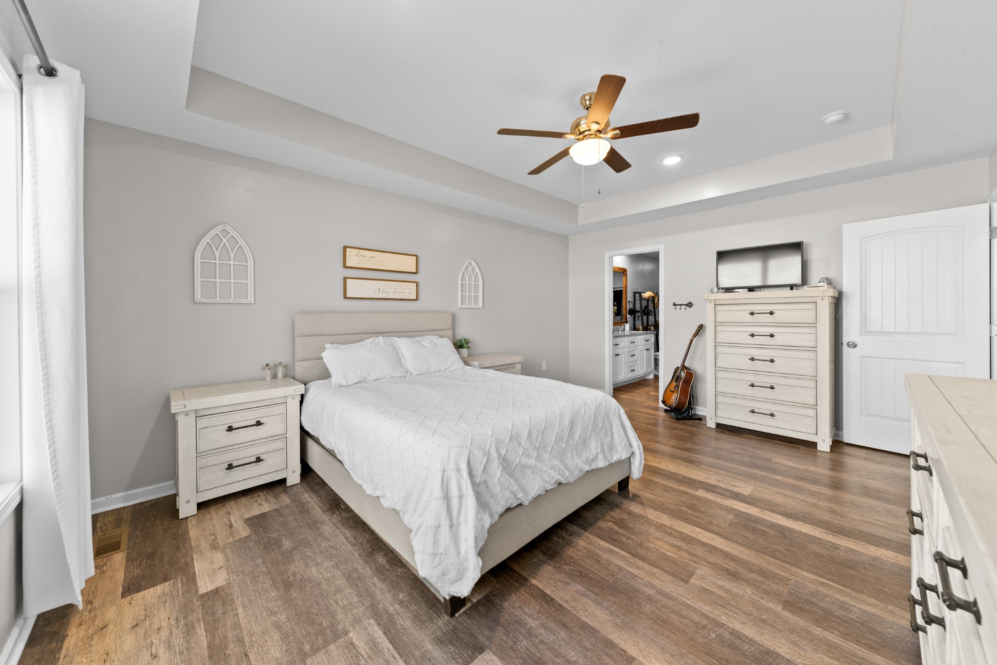 2023 Coleman Road Cornersville, TN 37047 - Photo 30 of 80 a spacious bedroom with a bed and a chandelier