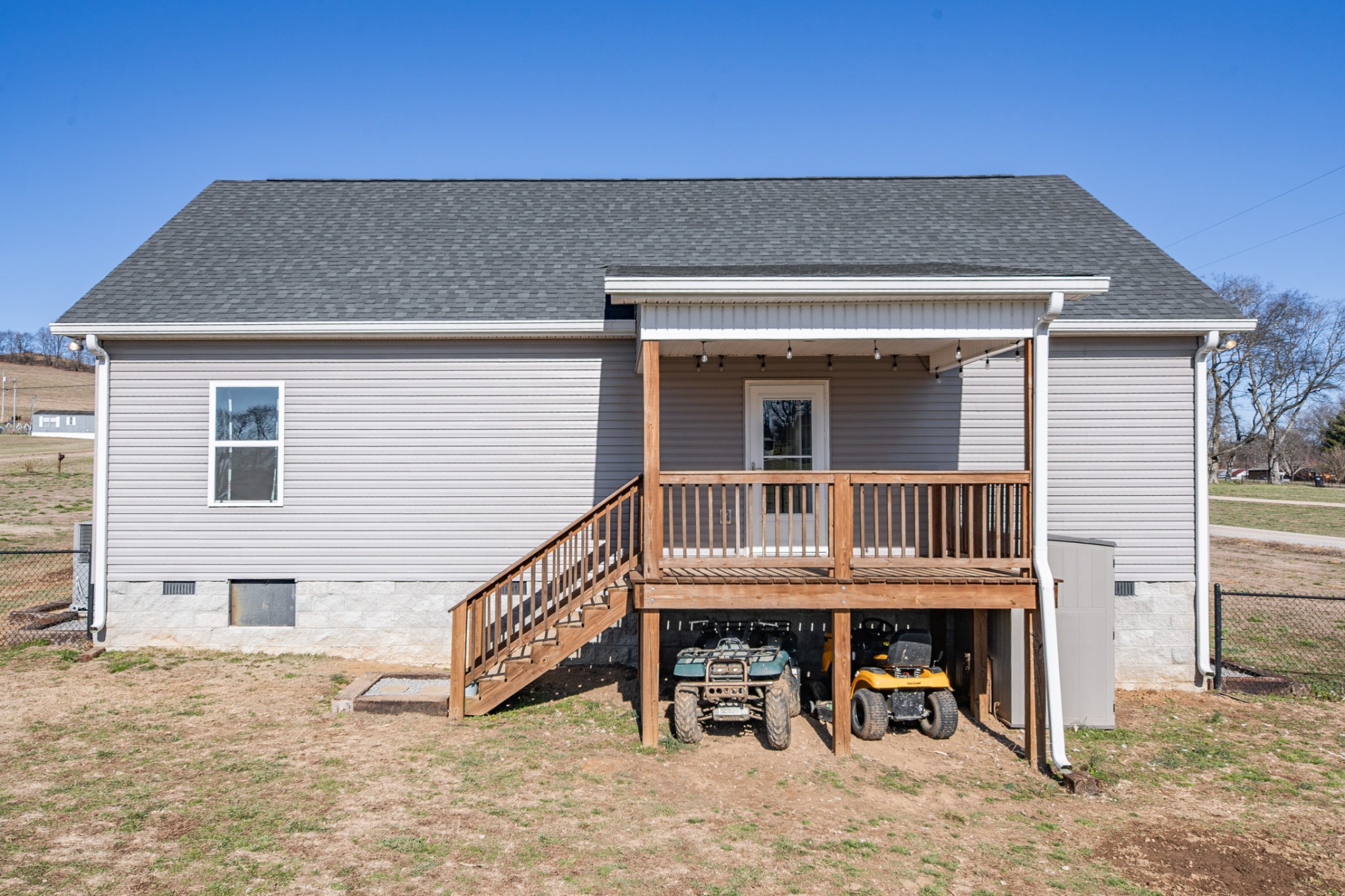 2023 Coleman Road Cornersville, TN 37047 - Photo 48 of 80 a view of a house with wooden deck and furniture