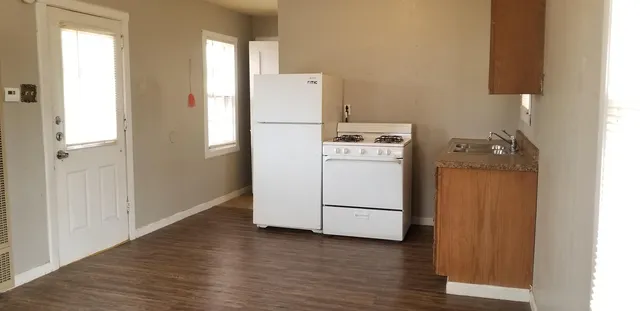 a utility room with cabinets washer and dryer
