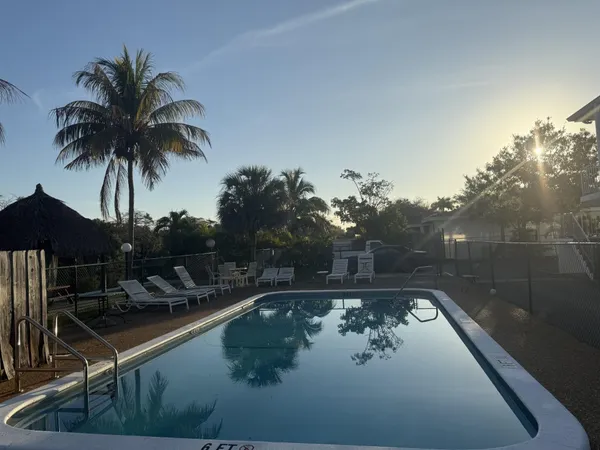 swimming pool view with a seating space