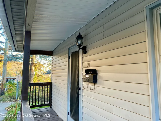 a view of a porch with wooden floor