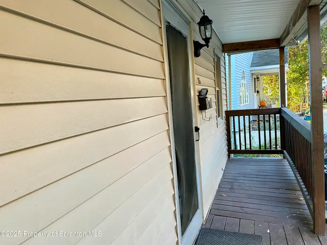 a view of a porch with wooden floor and stairs