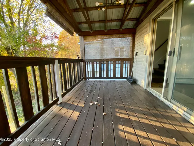 a view of balcony with wooden floor
