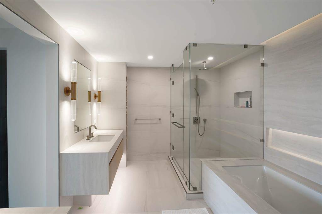 900 North Ocean Boulevard, Unit 906 Pompano Beach, FL 33062 - Photo 11 of 33 a bathroom with a tub shower sink and mirror