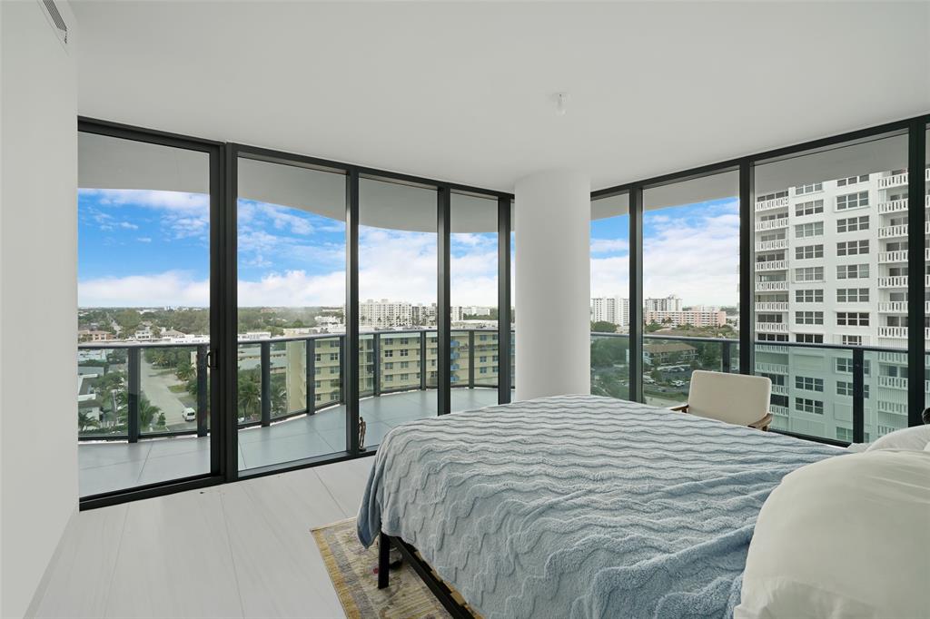 900 North Ocean Boulevard, Unit 906 Pompano Beach, FL 33062 - Photo 13 of 33 a bedroom with a large window and a bed