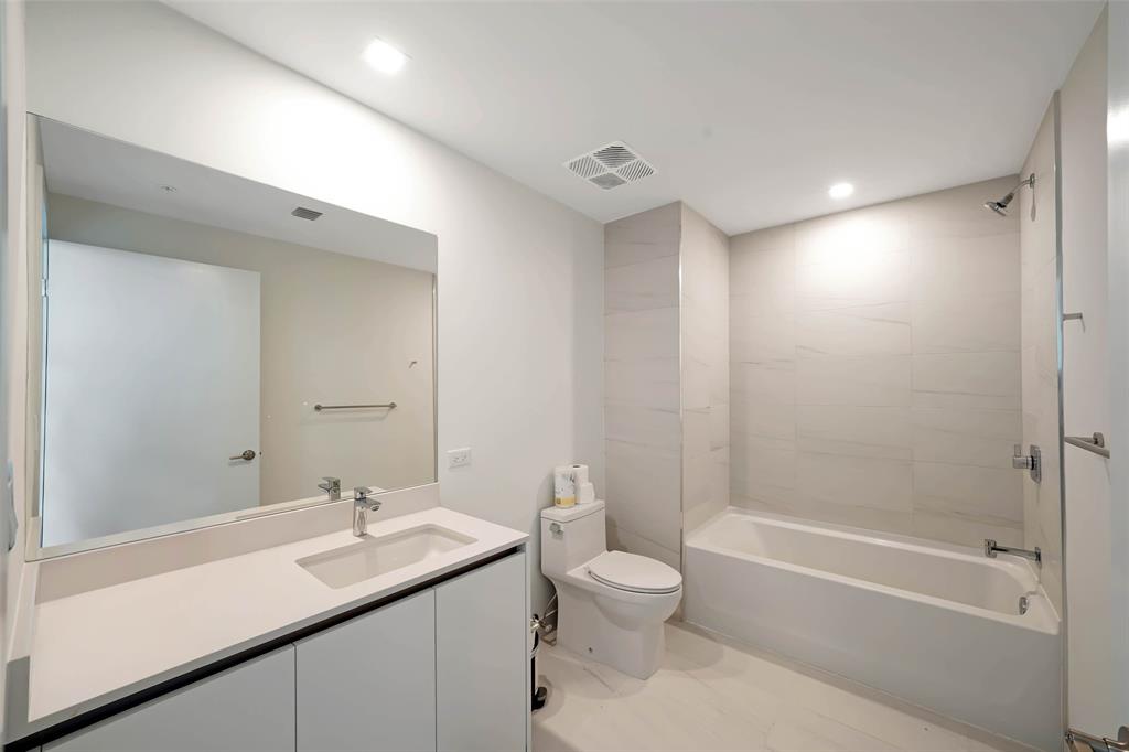 900 North Ocean Boulevard, Unit 906 Pompano Beach, FL 33062 - Photo 14 of 33 a bathroom with a sink toilet tub and shower