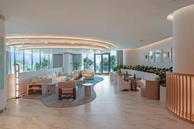 a living room with furniture a large window and a chandelier