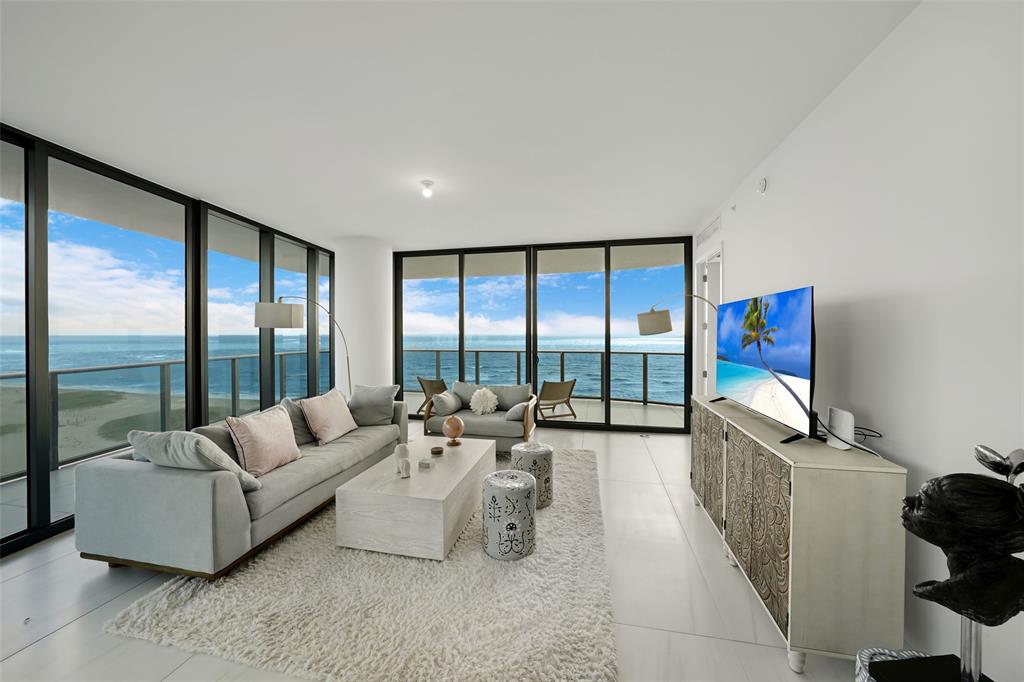 900 North Ocean Boulevard, Unit 906 Pompano Beach, FL 33062 - Photo 2 of 33 a living room with furniture and a large window