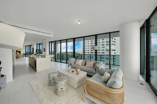 a large kitchen with kitchen island a large window a sink and stainless steel appliances