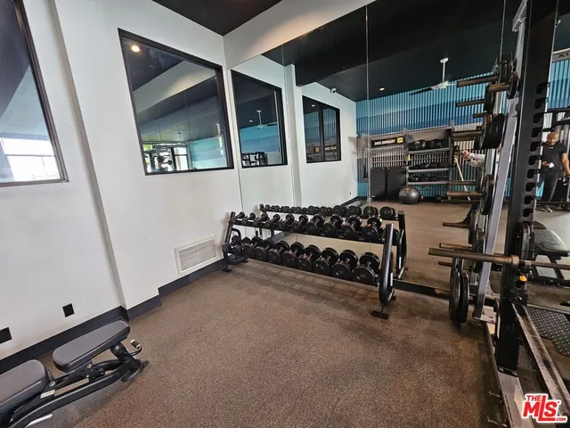 a room with gym equipment and a table