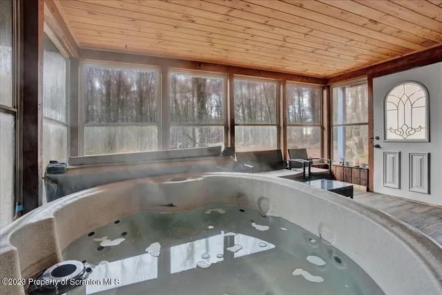 a view of a bathroom with tub and large windows