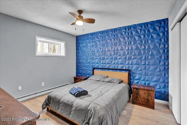 a bedroom with a bed and a chandelier