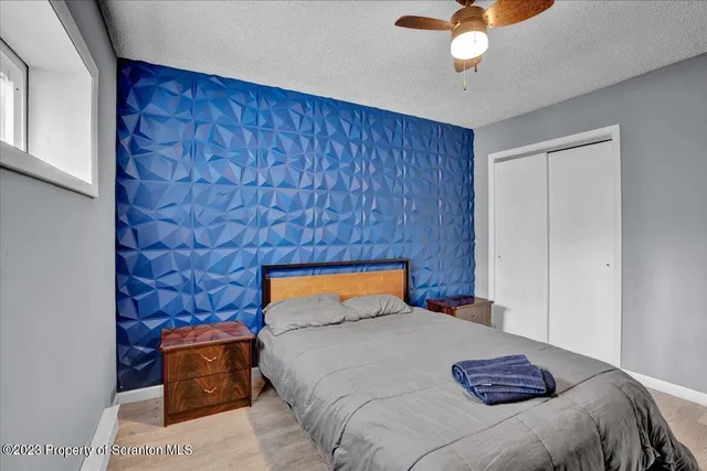 a bedroom with a bed and a chandelier