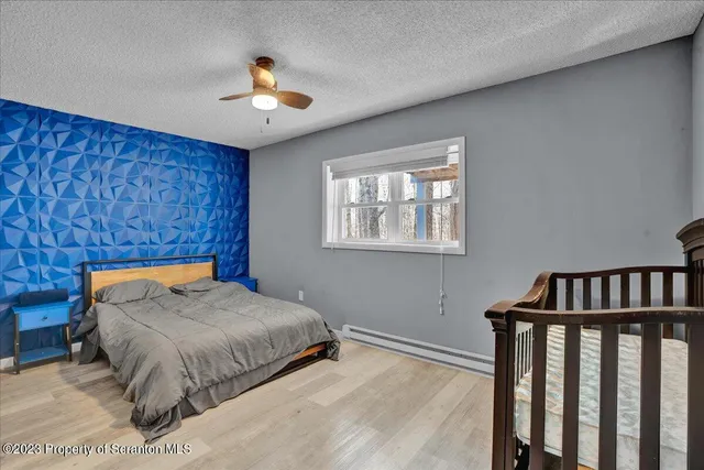 a bedroom with a bed and a chandelier
