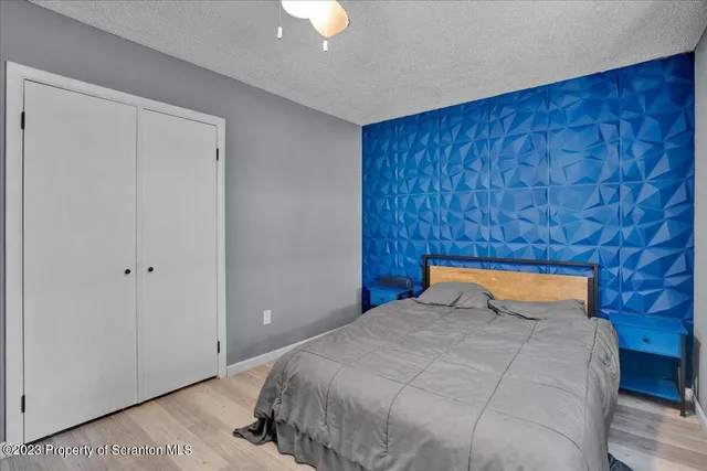 a bedroom with a bed and a lamp