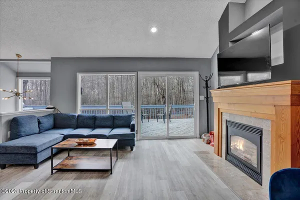 a living room with furniture a flat screen tv and a fireplace