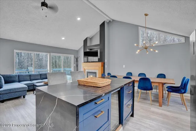 a living room with dining room and kitchen view