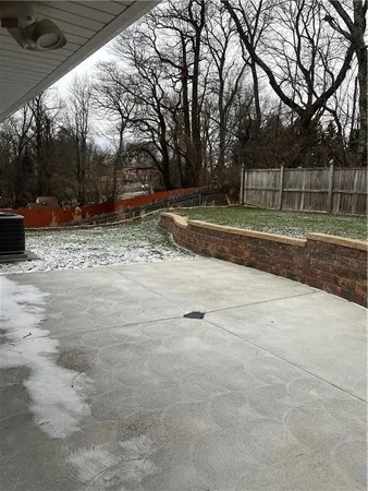 a view of a backyard with large trees