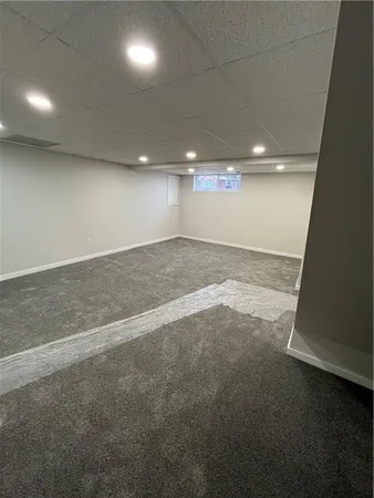 an empty room with a wooden floor and windows