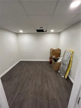 a view of room with wooden floor and furniture