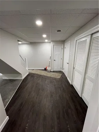 a view of empty room with wooden floor