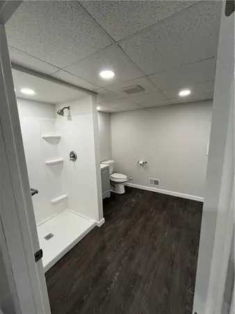a view of a room with wooden floor and furniture
