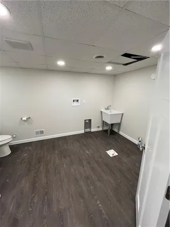 an empty room with wooden floor and white walls