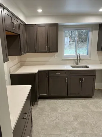 a kitchen with a sink and a refrigerator